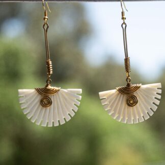 White serrated semicircular bone with brass hooks,springs and wires.
