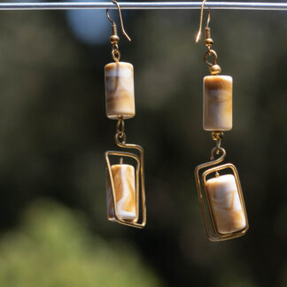 Brown & white bicylindrical shaped bone fixed with brass wire.