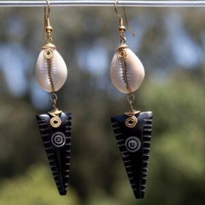 Brown inverted triangular shaped bone + Shell fixed with brass wire.
